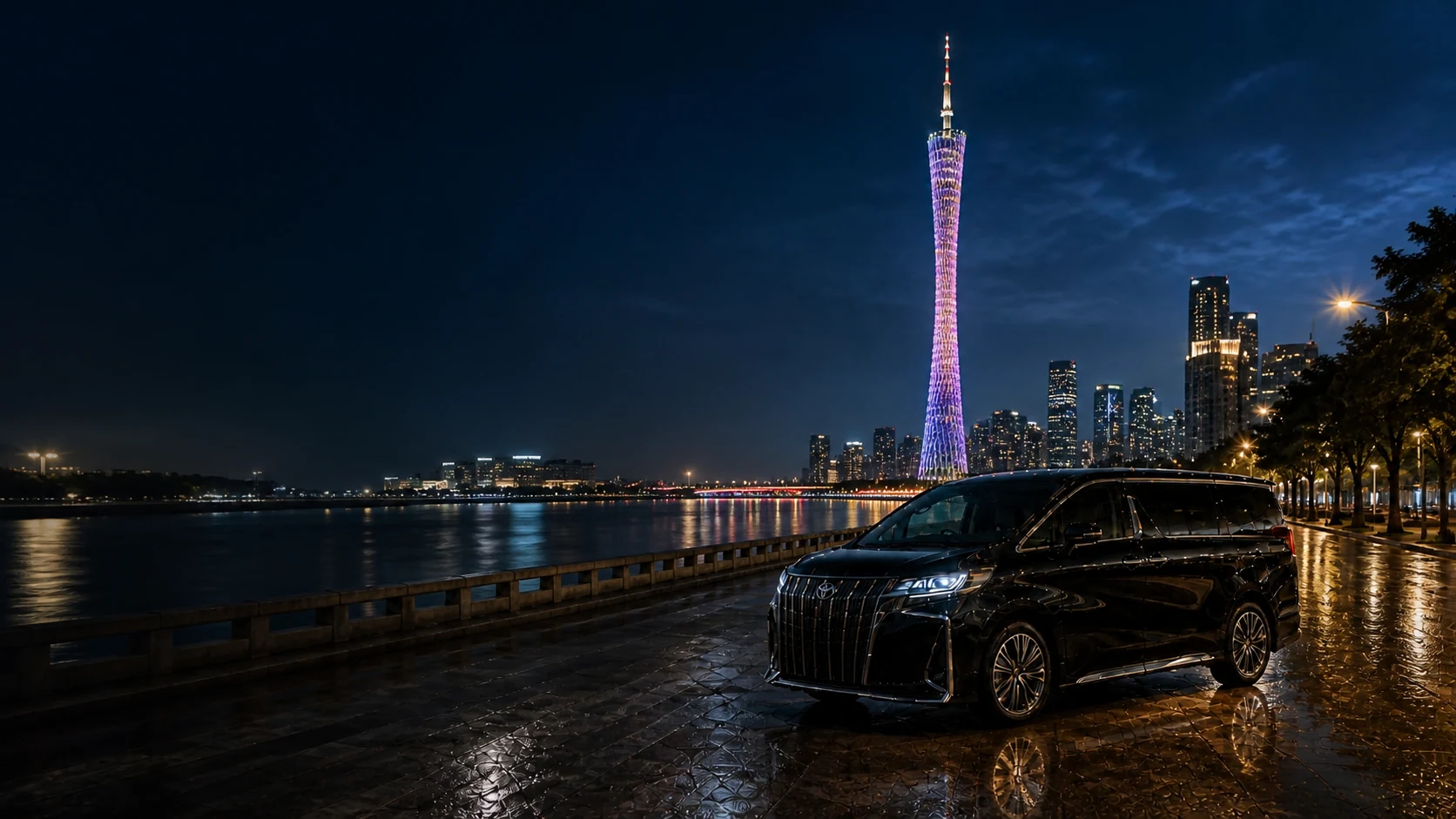 Executive MPV beside the illuminated Canton Tower and Guangzhou skyline at night